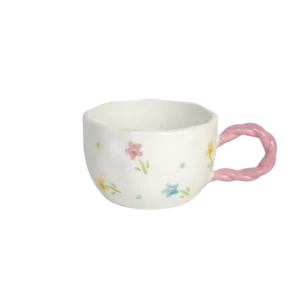 Ceramic floral design mug with pink handle