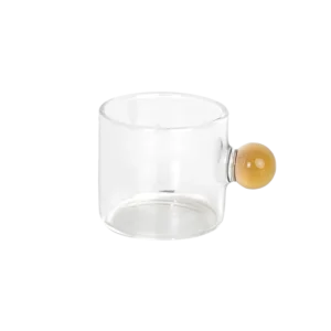 Small glass transparent coffee cup with yellow ball handle